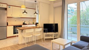 A modern apartment with a kitchen, dining area, and living room. - 1BR next to Pasalimani, Marina Zeas & Hospital (Pireas)