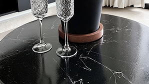 A black marble table with a champagne bottle and two crystal glasses. - NOAM by the sea Ocean View Suite #4 Adults Only (Tamarindo)