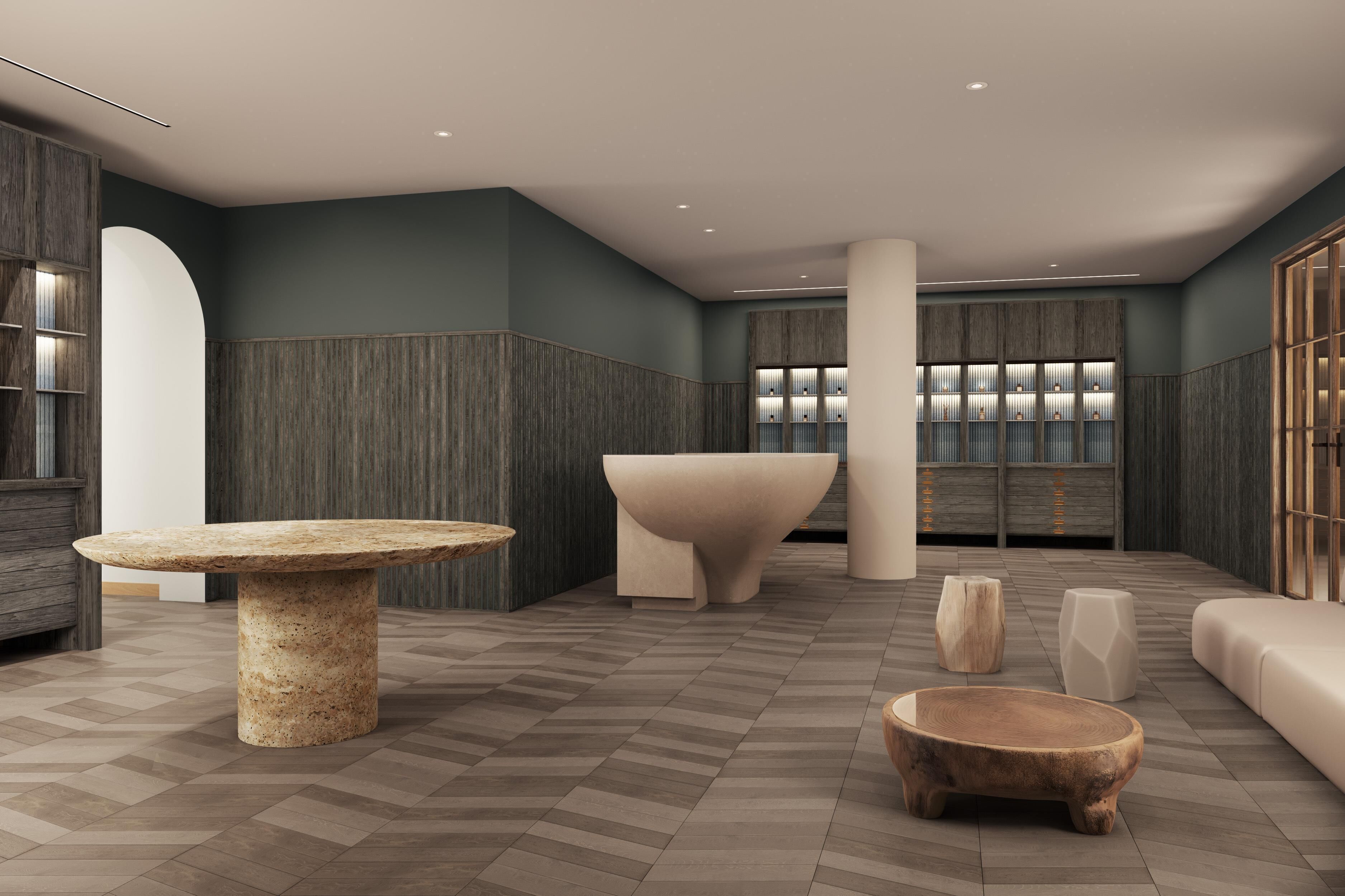 A modern interior with a central seating area, a large table, and a reception desk.