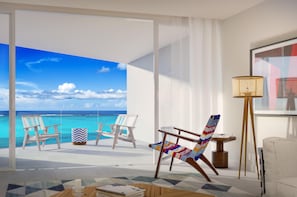 A room with a large glass door leading to a balcony with a view of the ocean. There are two wooden chairs and a colorful woven chair on the balcony. - Andaz Turks And Caicos At Grace Bay (Providenciales)
