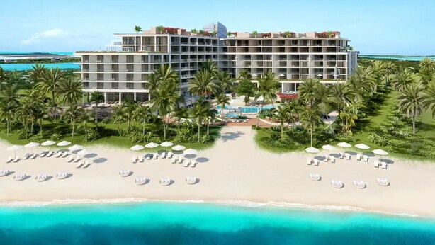 A beachfront hotel with multiple floors, a pool area, and palm trees. - Andaz Turks And Caicos At Grace Bay (Providenciales)