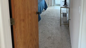 A bedroom with a bed, a desk, and a window with curtains. - Waterfront Lemon Bay Condo 2 Bed & Full Kitchen -Private Beach Access Boat dock (Englewood)