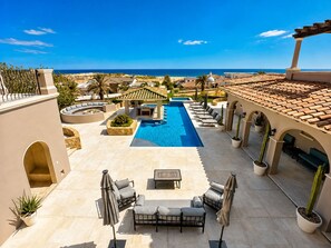A pool area with lounge chairs and a view of the ocean. - Diamante Beach Estate • Cabo San Lucas • Luxury Golf Resort with Ocean Views (Cabo San Lucas)