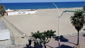 Una playa con cielo despejado, un letrero que dice 'Sea Line' y una palmera.