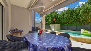 An outdoor patio with a round table, chairs, a pool, and a stone structure. - House 2447/252732 (Istria - Banjole), 1000m from the beach (Banjole)
