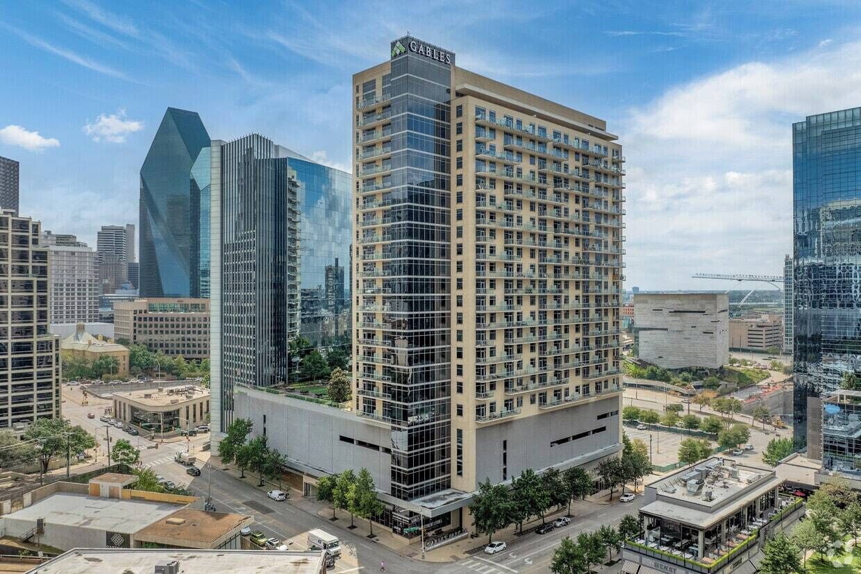 A high-rise hotel with multiple floors, a prominent 'GABLES' sign, and a modern glass facade.