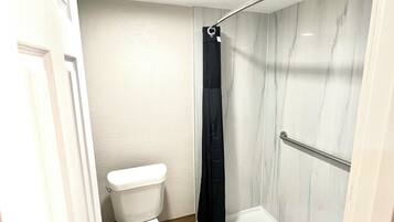 Deluxe Room, 1 King Bed | Bathroom | Shower, towels, soap, toilet paper