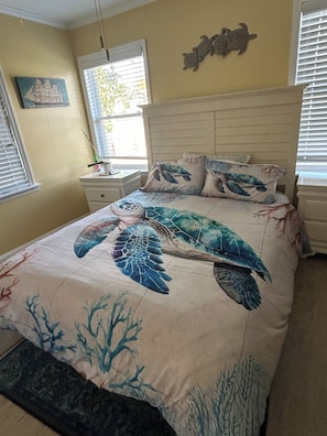 A bedroom with a bed, a nightstand, a window, and a wall decoration. - 2-bedroom house in fantastic Lower Township back yard and patio (Lower Township)