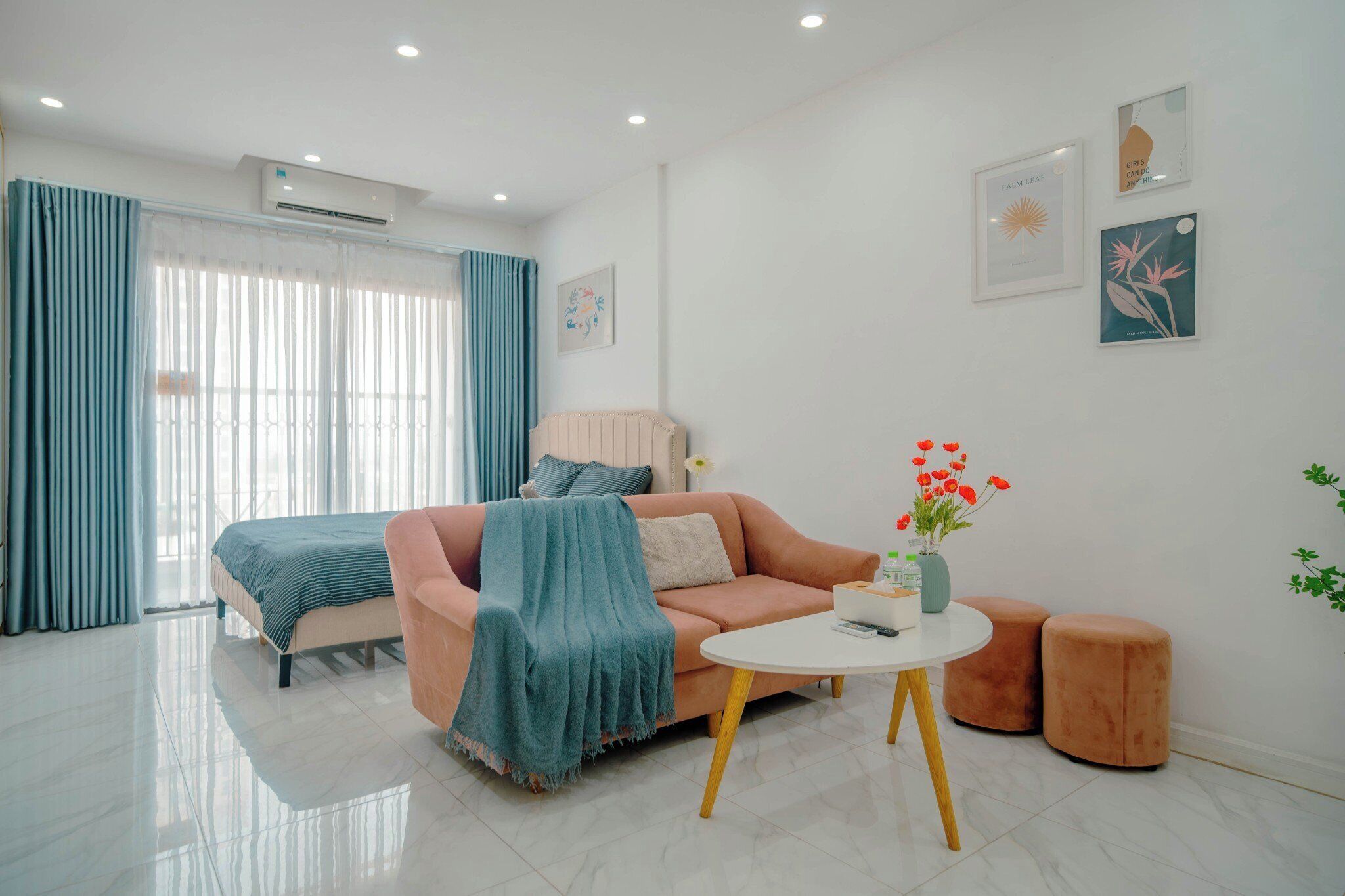 A modern living room with a sofa, a coffee table, and a bed.