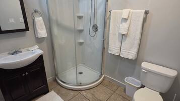 Shower, hair dryer, towels, toilet paper