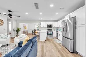 A modern kitchen with white cabinets, stainless steel appliances, and a central island. - Peaceful Getaway~ Heated Pool ~10 Min to Beach (Largo)