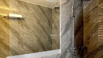 A modern bathroom with a shower, toilet, and sink.