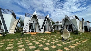 A modern building with triangular roofs and a central seating area.