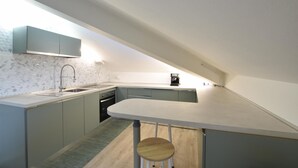 Una cocina moderna con estufa integrada, un fregadero y una cafetera.
