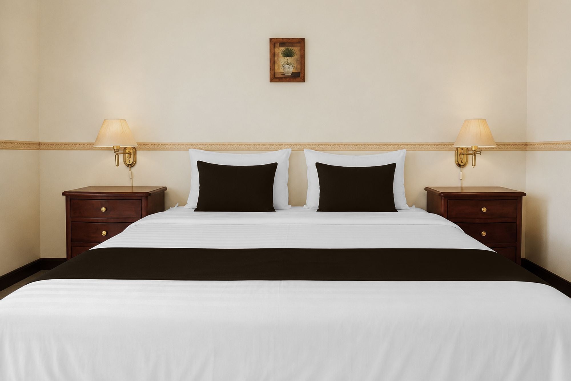 Une chambre d’hôtel avec un lit, deux tables de chevet et un tableau accroché au mur.