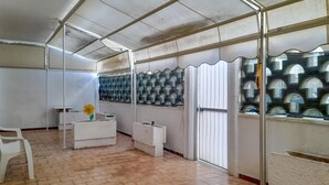 A room with a tiled floor, white furniture, a decorative wall, and a window with a patterned screen. - Awesome apartment in Maglie with WiFi (Maglie)