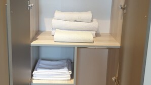A walk-in closet with shelves and drawers for storage. - Peaceful and secure Kyanja Oasis with Modern Amenities & Hot Shower (Kampala)