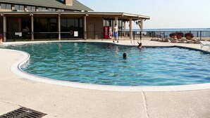 A swimming pool with a covered area, a Coca-Cola cooler, and a view of the ocean. - Fishing on the Overwater Balcony! 2BR/2BA Condo with Beautiful Lake Conroe View (Willis)