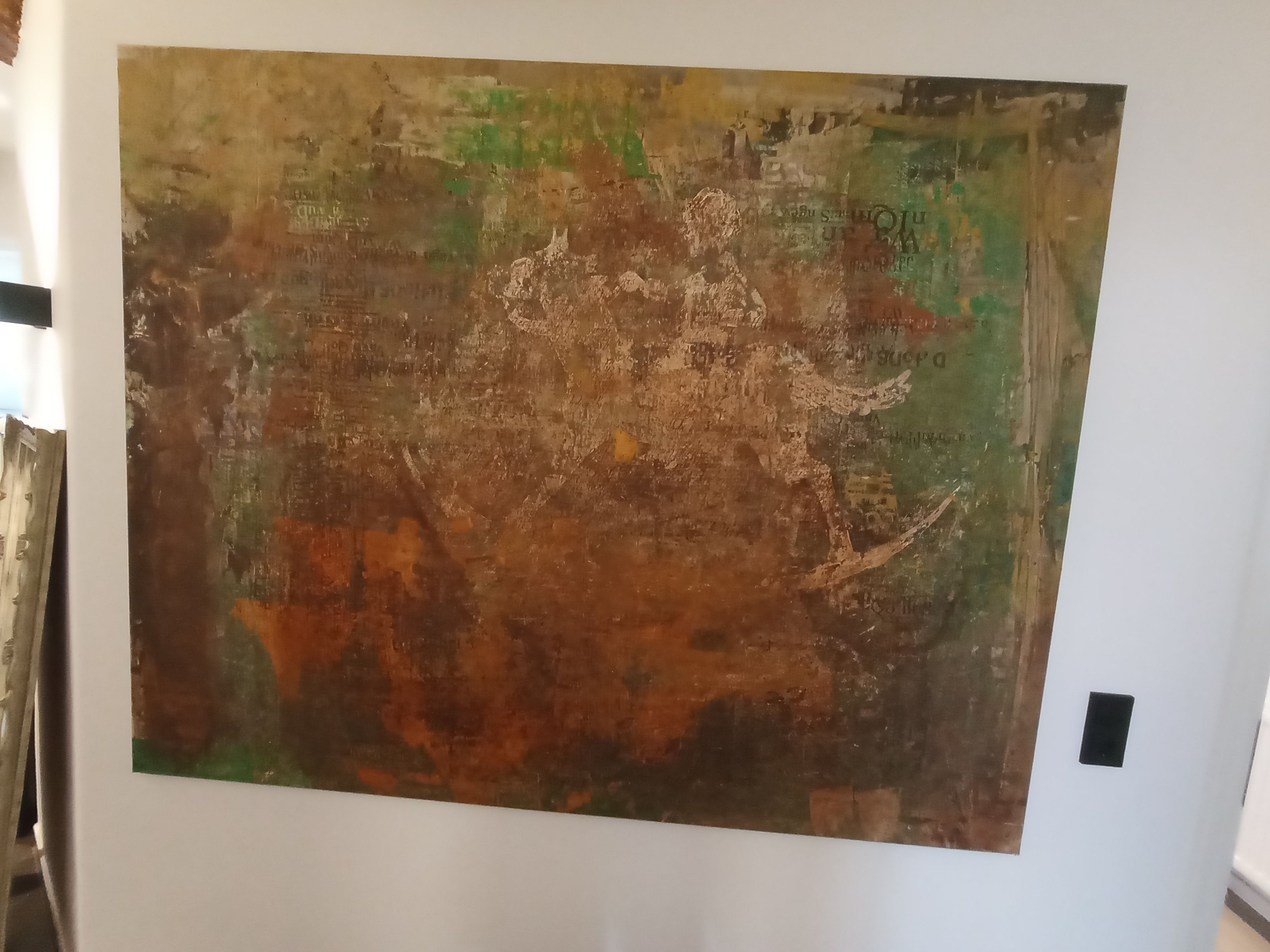 A large abstract painting on a wall.