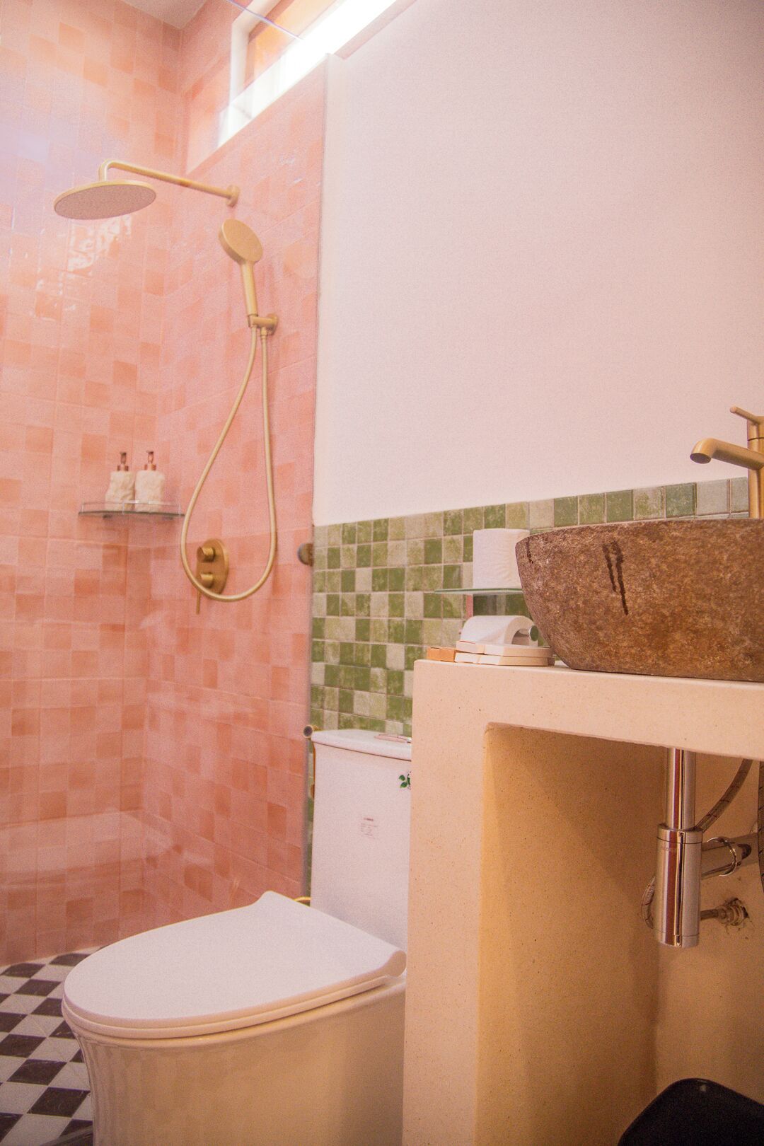 A bathroom with a shower, toilet, and sink.