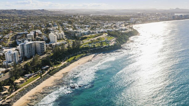 An aerial view of a coastal city with high-rise buildings, a beach, and a clear sky. - Coastal Rooftop Escape Mooloolaba - Walk to Beach (Mooloolaba Region)