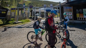Un espace extérieur ensoleillé comprenant un bâtiment, un panneau indicateur et un vélo.