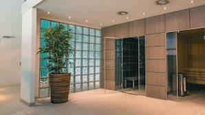 A modern interior with a large glass wall, a potted plant, and a wooden cabinet. - Holiday Home in Dordrecht With Terrace (Dordrecht)
