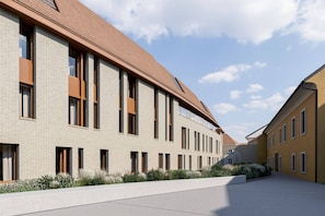 A modern building with a brick facade, large windows, and a flat roof. - Hotel Maribor - Pavilion  (Maribor)