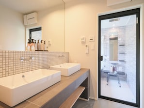A modern bathroom with two sinks, a large mirror, and a glass door leading to a shower area. - KAMAKURA VILLA SAUNA KOSHIGOE 5 (Koshigoe, Kamakura-shi)