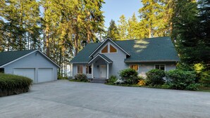 A two-story house with a front garage, a covered porch, and a driveway.