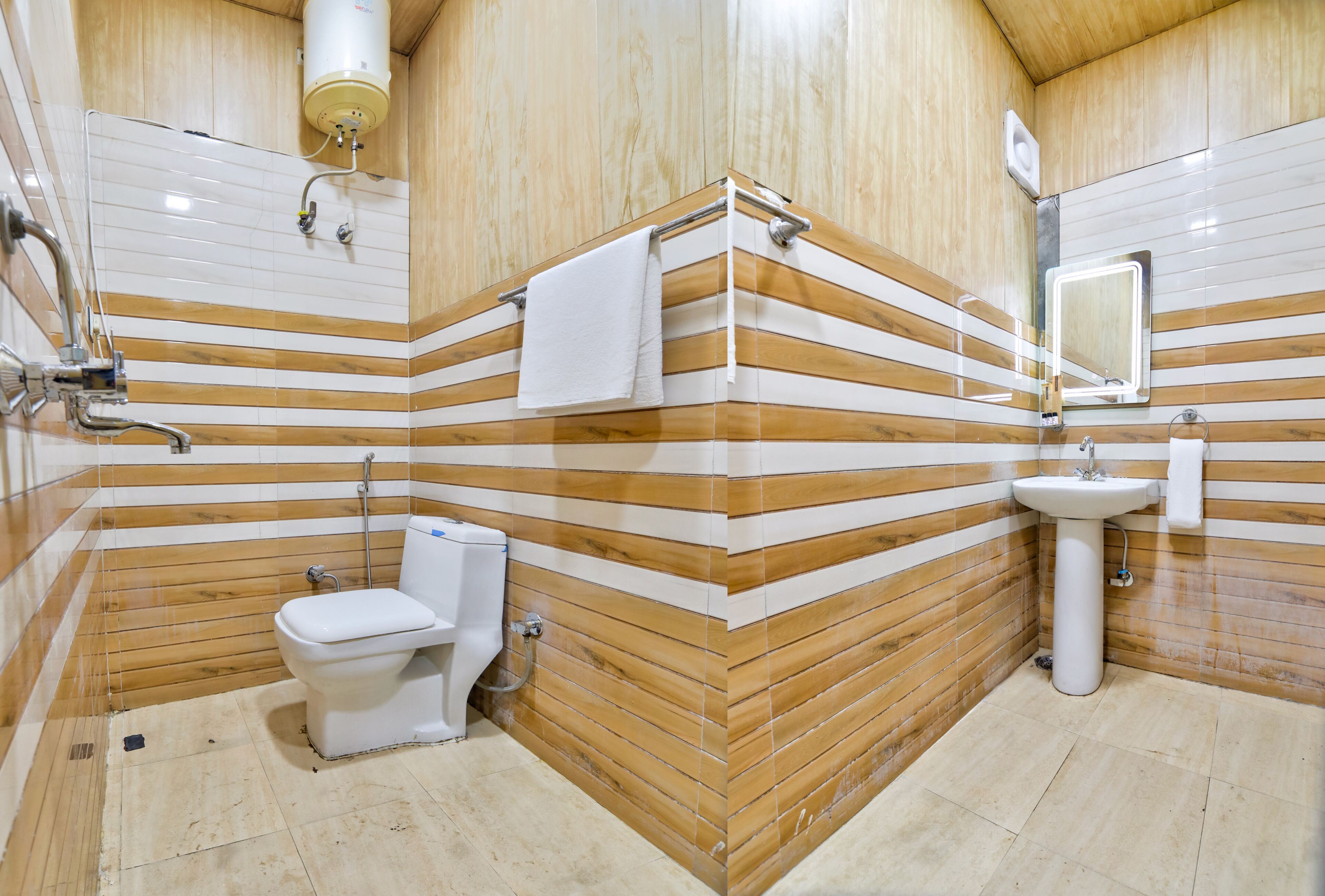 A bathroom with a wooden panel design, a toilet, a sink, and a mirror.