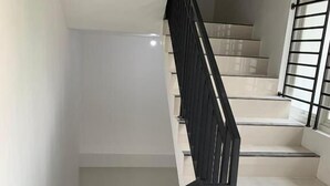 Una escalera con barandales negros y peldaños blancos.
