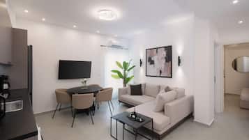 Comfort Apartment | Living area | 50-inch Smart TV with satellite channels