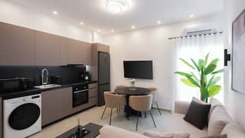 A modern apartment with a kitchen, dining area, and living room.