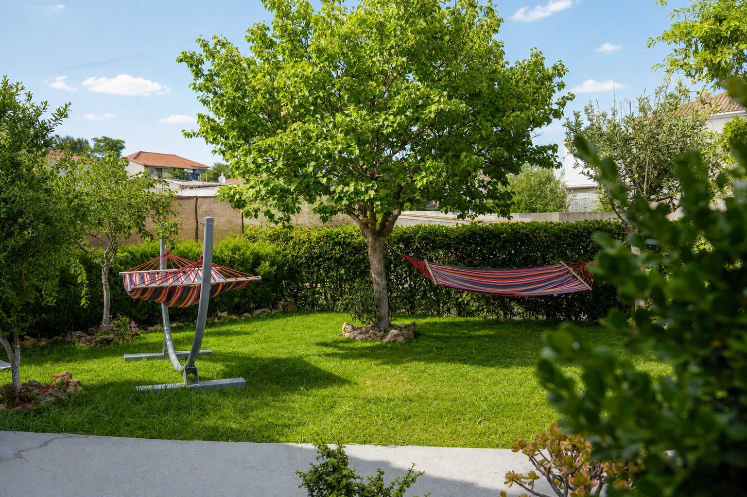 Private garden with hammock and shaded lawn