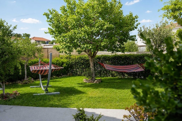 Private garden with hammock and shaded lawn