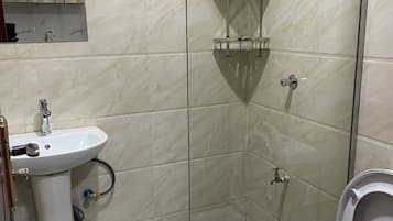Deluxe Studio | Bathroom | Shower, slippers, towels, soap