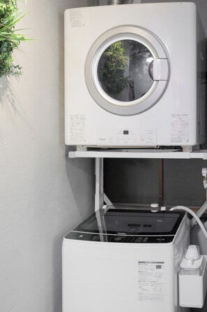 A front-loading washer and dryer stacked vertically with a control panel and a power cord. - SNUGGLE2222 Odawara Nakacho / Odawara City Kanagawa (Odawara City)
