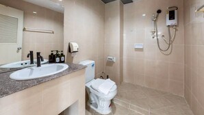 A bathroom with a sink, toilet, and shower.