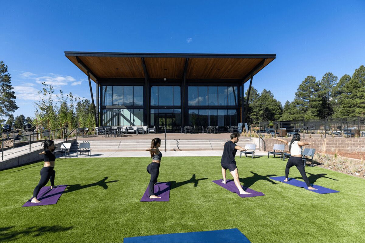 An outdoor yoga area with a modern building in the background.