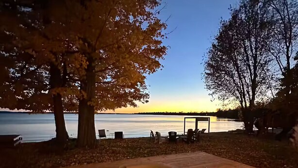 A hot tub with a view of a lake at dusk. - Bees Beach House: Luxury 5BR Sturgeon Lakefront w/ Private Sandy Beach & Sauna (Kawartha Lakes)