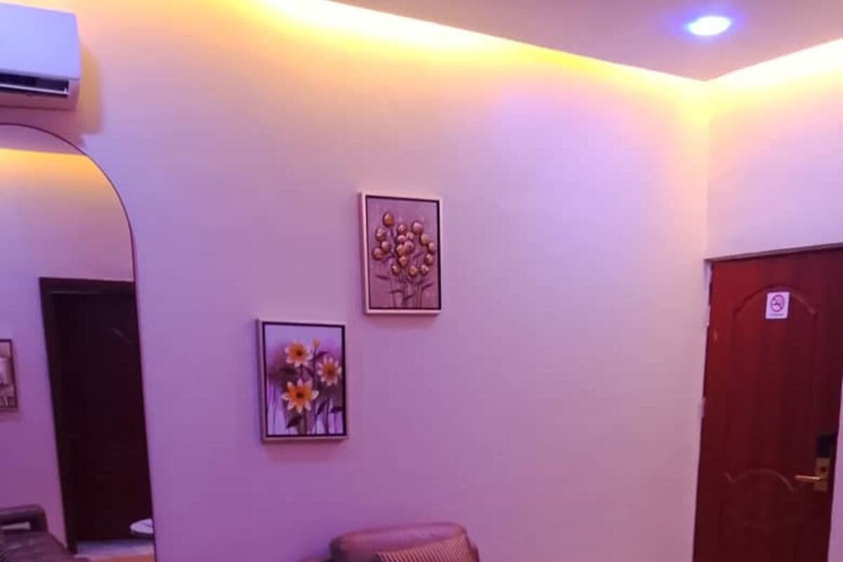 A living room with a sofa, armchair, and round coffee table.