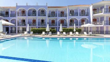 Seasonal outdoor pool, open 10:00 AM to 6:00 PM, pool umbrellas