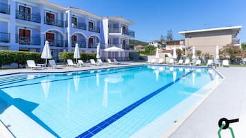 Seasonal outdoor pool, open 10:00 AM to 6:00 PM, pool umbrellas