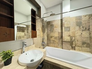 A modern bathroom with a bathtub, sink, and shower. - Satori1 Apartment (Hanoi)