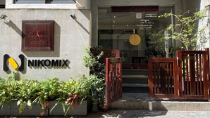 A building with a sign for 'Satori Exclusive apt' and 'NIKOMIX'. - Satori1 Apartment (Hanoi)