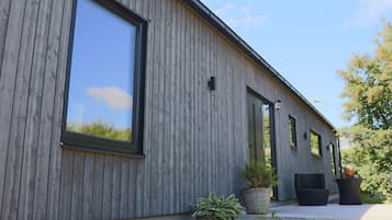 Un edificio moderno con amplios ventanales y fachada de madera.