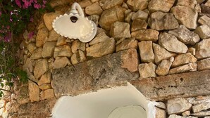 A stone archway leading to a door with a window. - Villa 'Resort I Trulli Torre Suda' with Private Pool, Wi-Fi and Air Conditioning (Torre Suda)