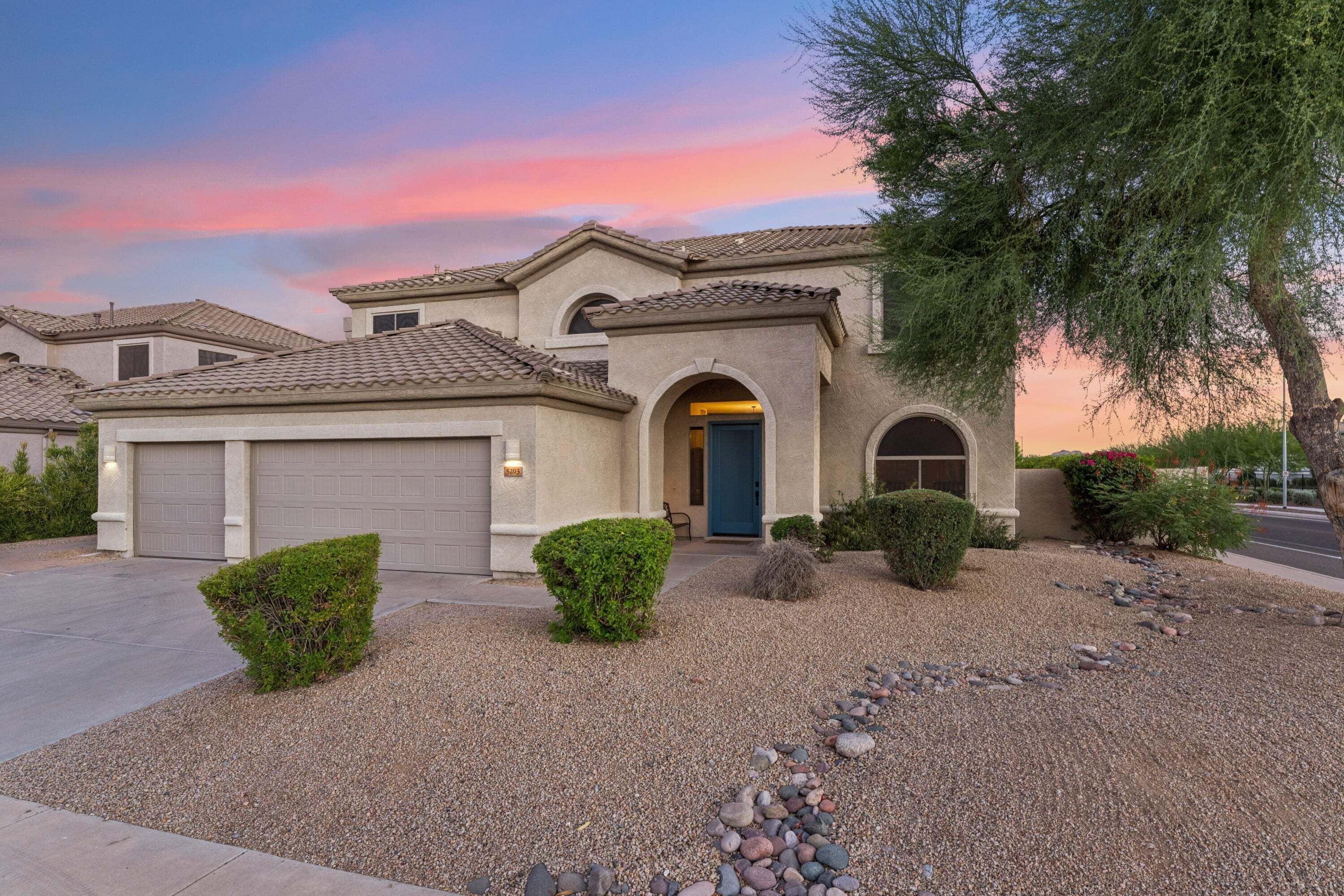 A residential house with a garage, a front door, and a driveway.