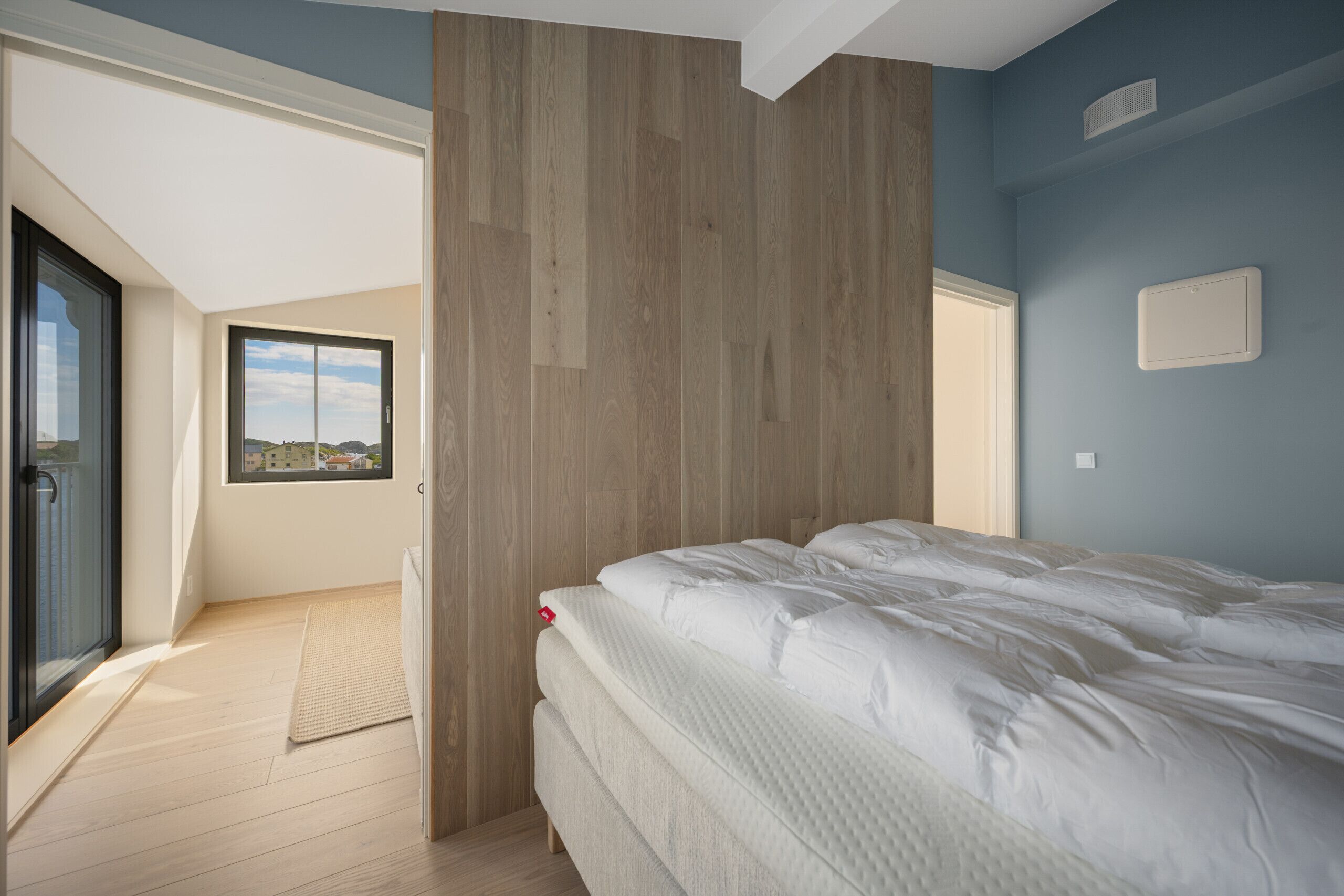 Une chambre à coucher avec un lit, une fenêtre et une vue sur l’extérieur.